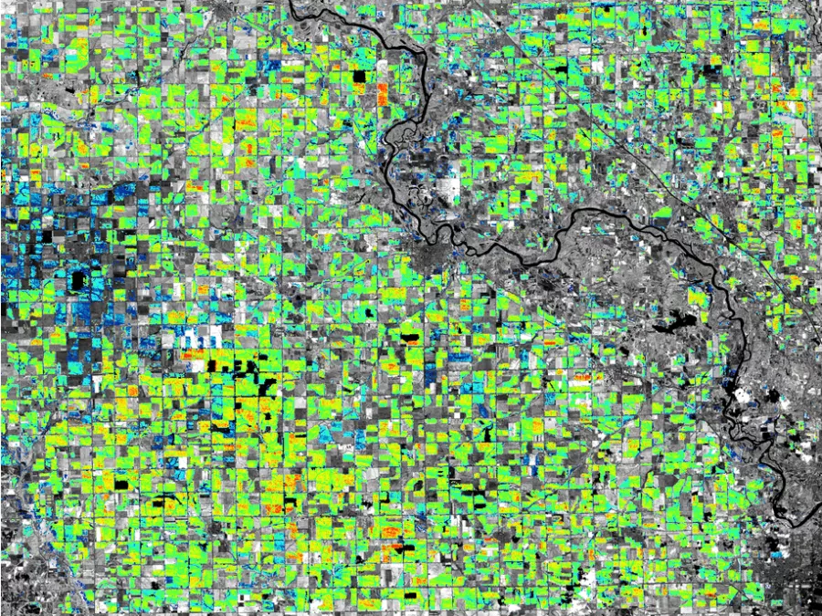 Patchwork of agricultural fields viewed from above showing the health of cornfields, as measured by the infrared reflectiveness of Descartes Labs geospatial intelligence software.